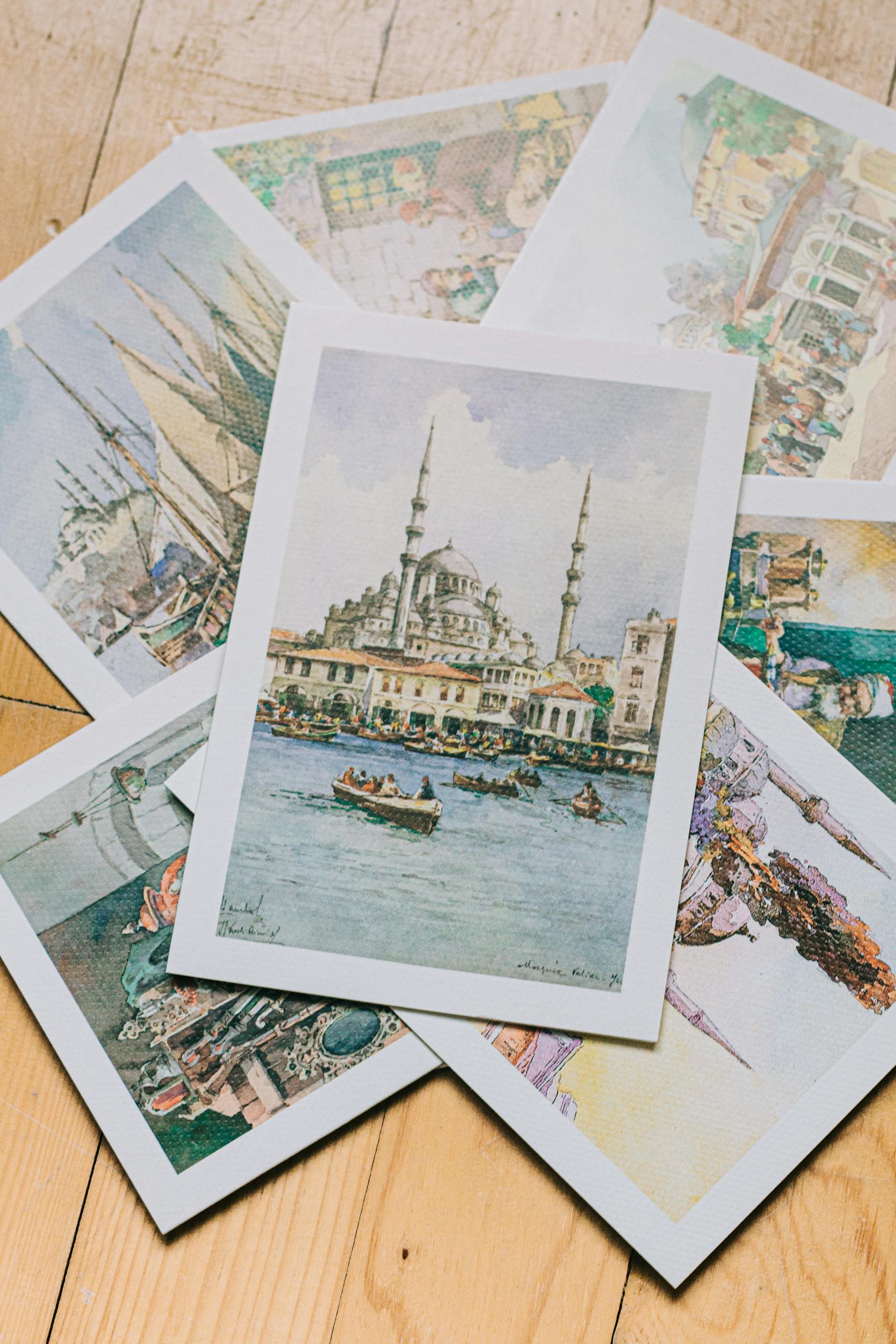 Newspaper Picture Frame A collection of beautifully illustrated vintage art postcards displayed on a wooden surface.