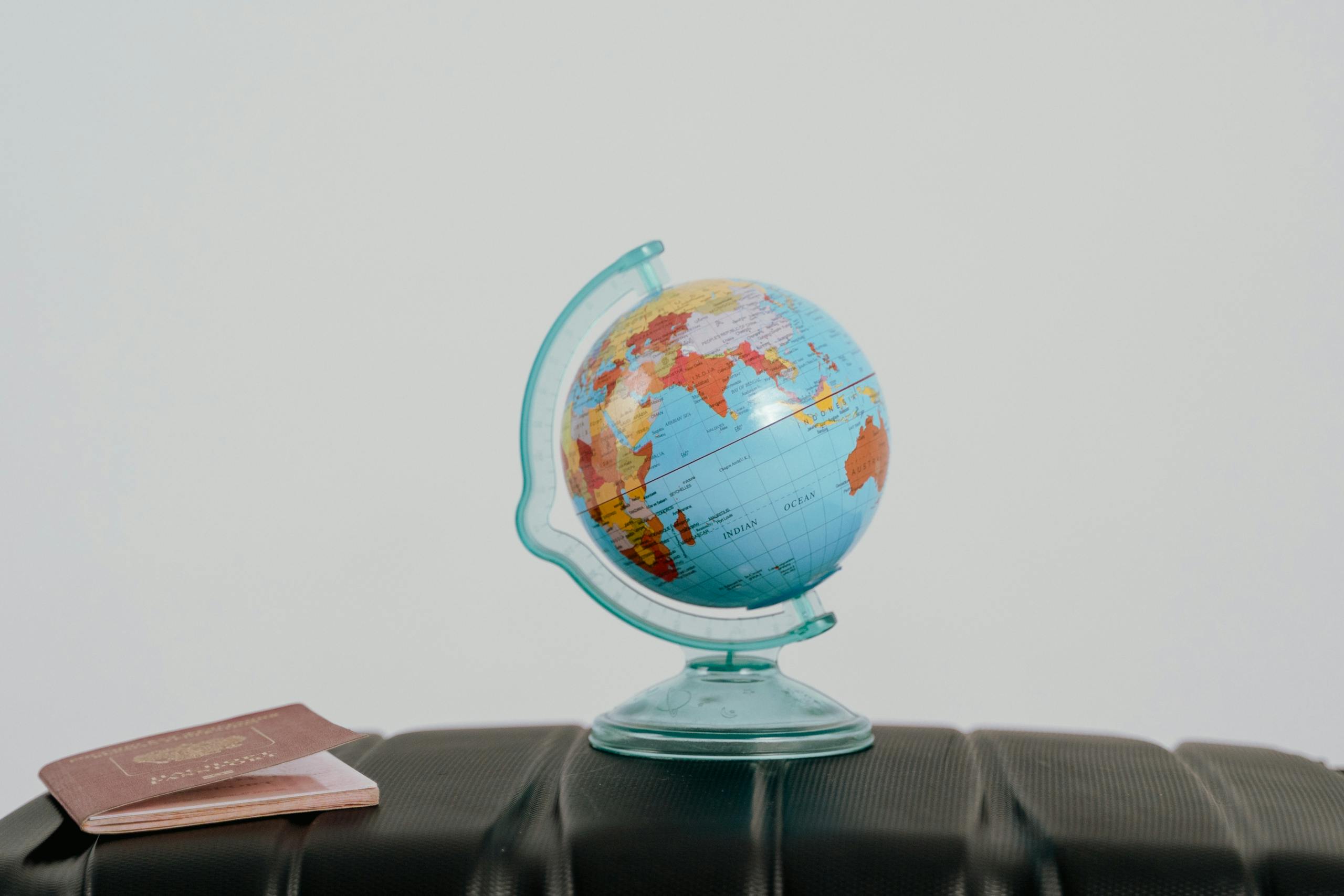 Discovering albfilm24 — A Complete Guide 2026 A globe and passport on a suitcase, symbolizing travel planning and wanderlust.