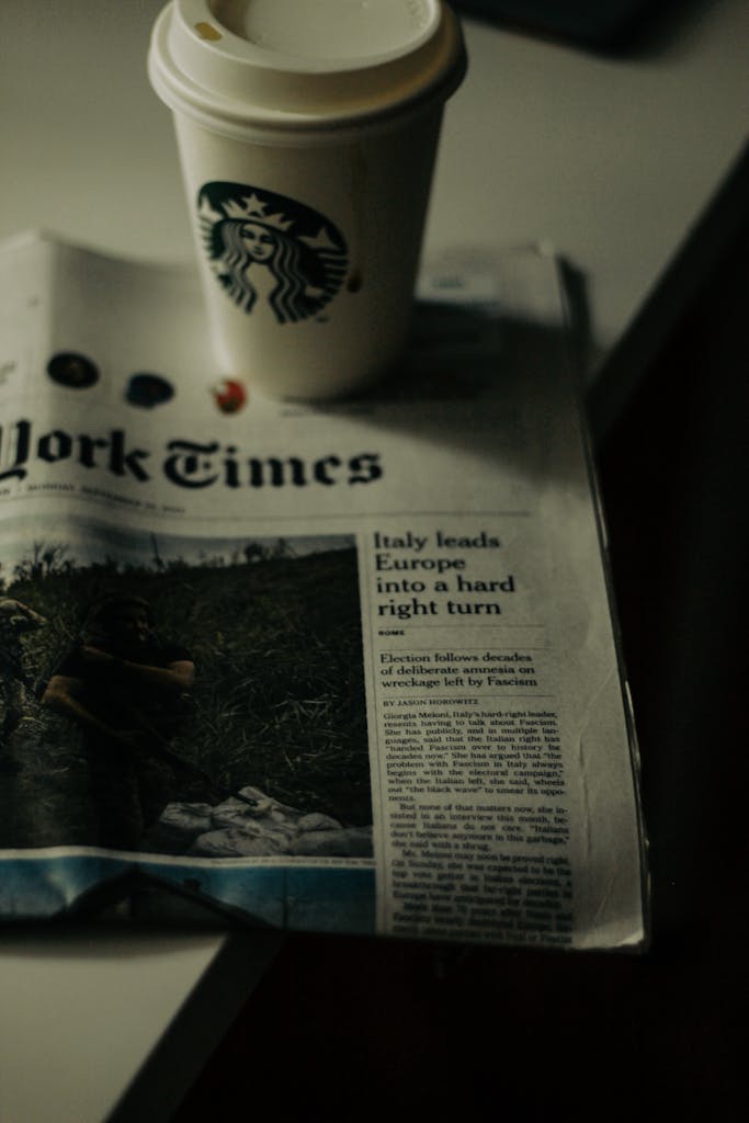 USA News Channel Live A Starbucks coffee cup sits atop a New York Times newspaper, creating a classic morning scene in New York.