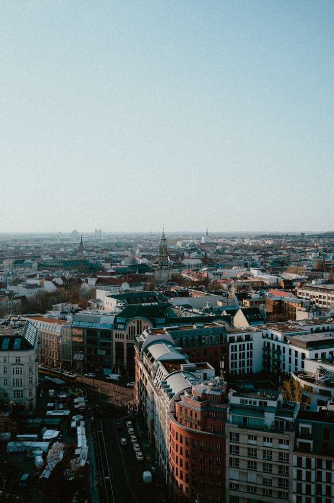 A stunning aerial view of a bustling cityscape showcasing architectural diversity under a clear sky.