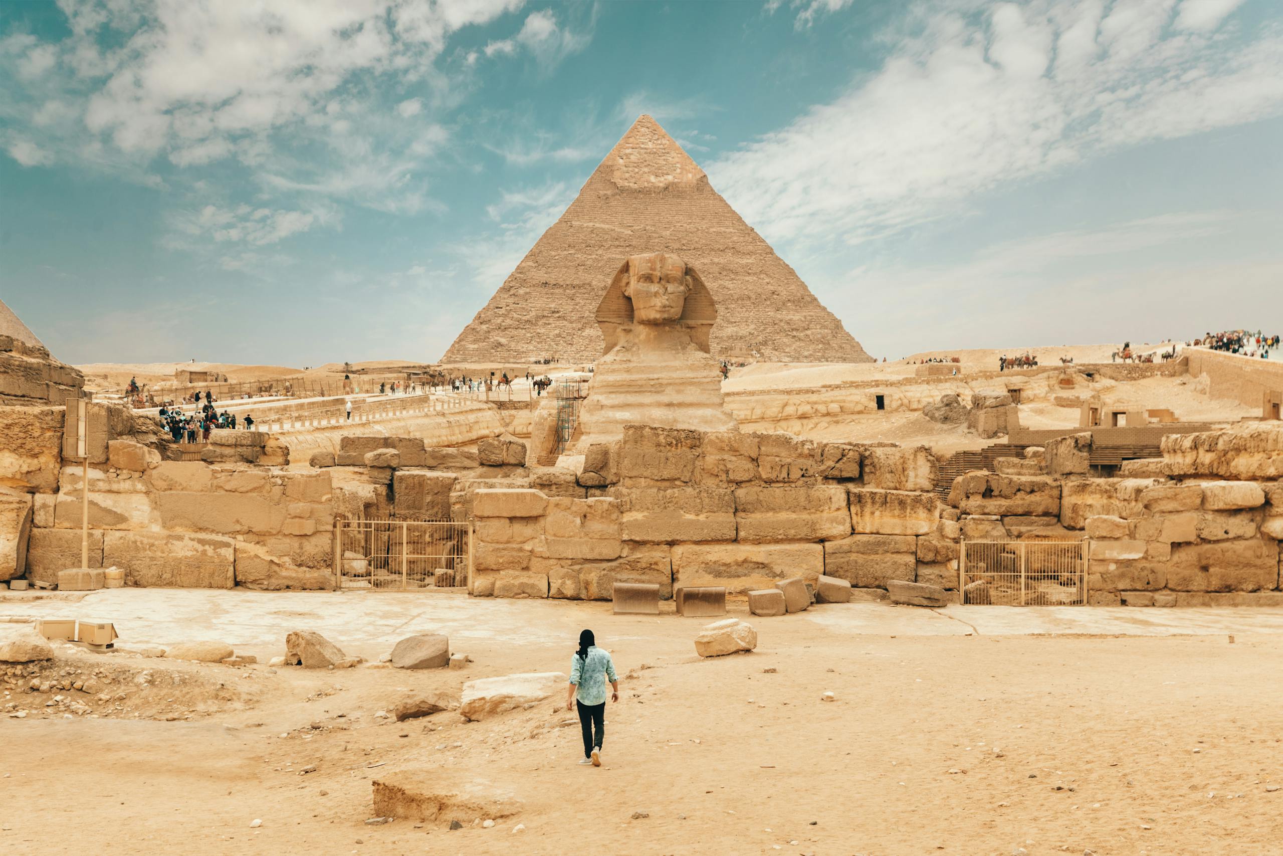 To Visit Vuzillfotsps Back view of unrecognizable man walking towards ancient monument Great Sphinx of Giza