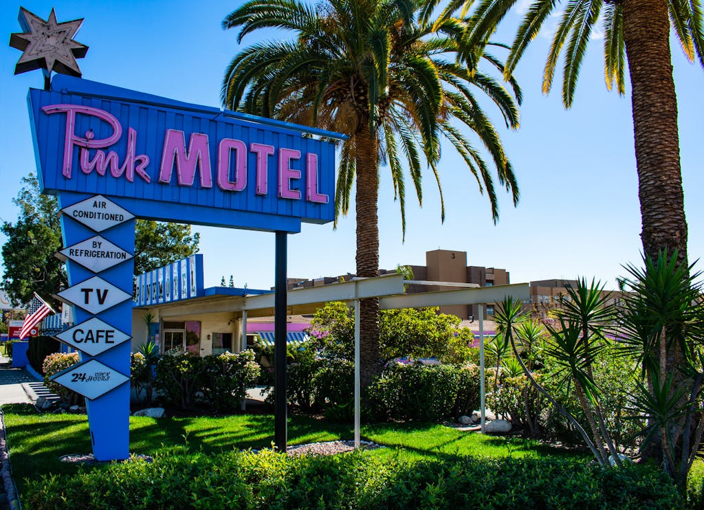 Iconic retro Pink Motel sign with palm trees in Sun Valley, Los Angeles.