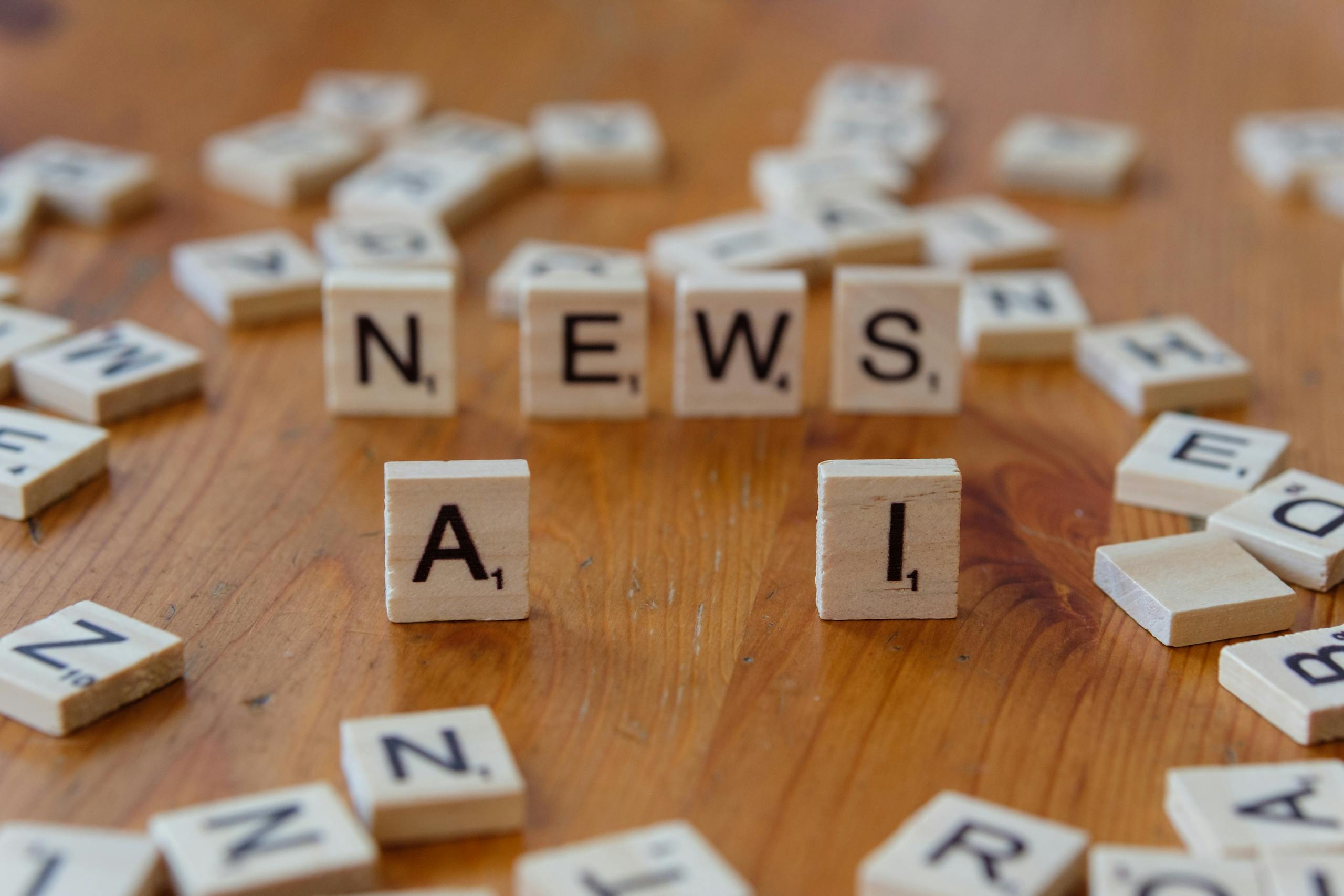Game News eTrueSports Wooden Scrabble tiles spelling 'AI' and 'NEWS' for a tech concept image.