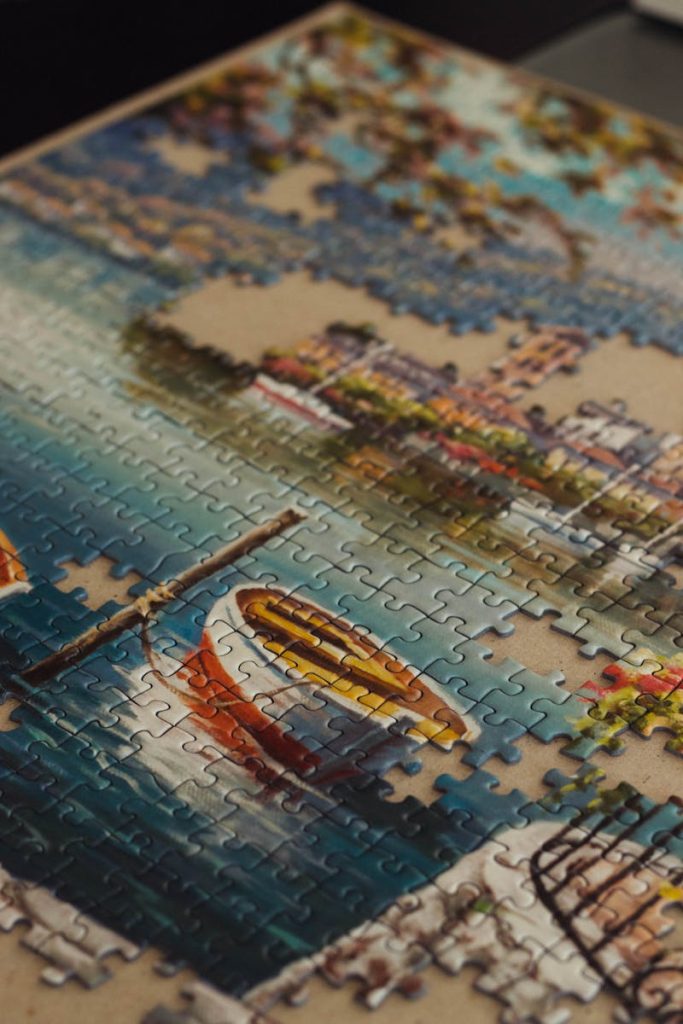 Completed jigsaw puzzle showcasing a vibrant waterfront scene with boats.