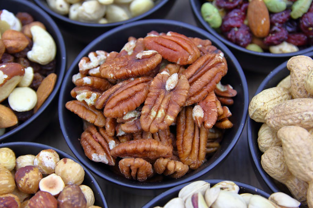 A close-up view of various nuts in bowls, perfect for healthy snacking.