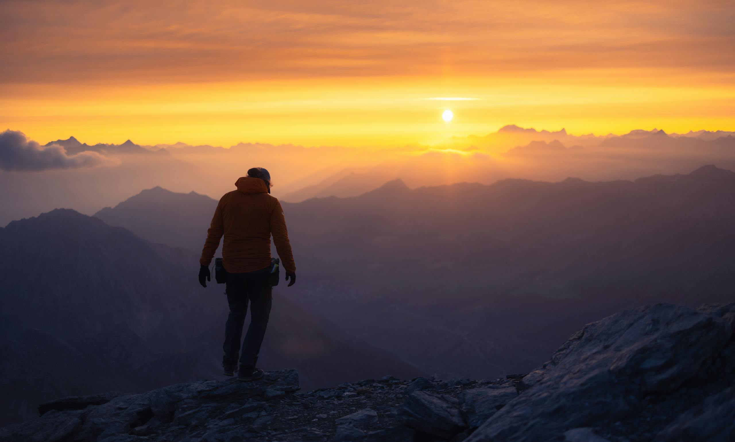Downnews: A Complete Guide to Understanding Digital News in the Modern Age 2026 vA lone hiker silhouetted against a vibrant mountain sunrise.