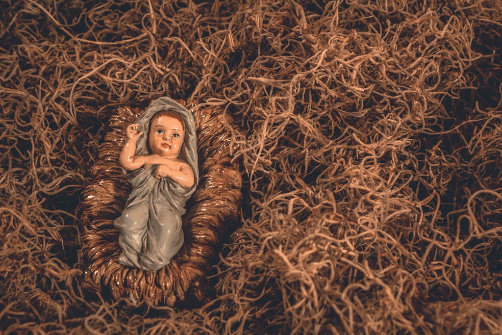 Angel Numbers A nativity scene featuring a baby Jesus figurine surrounded by straw, symbolizing hope and tradition.