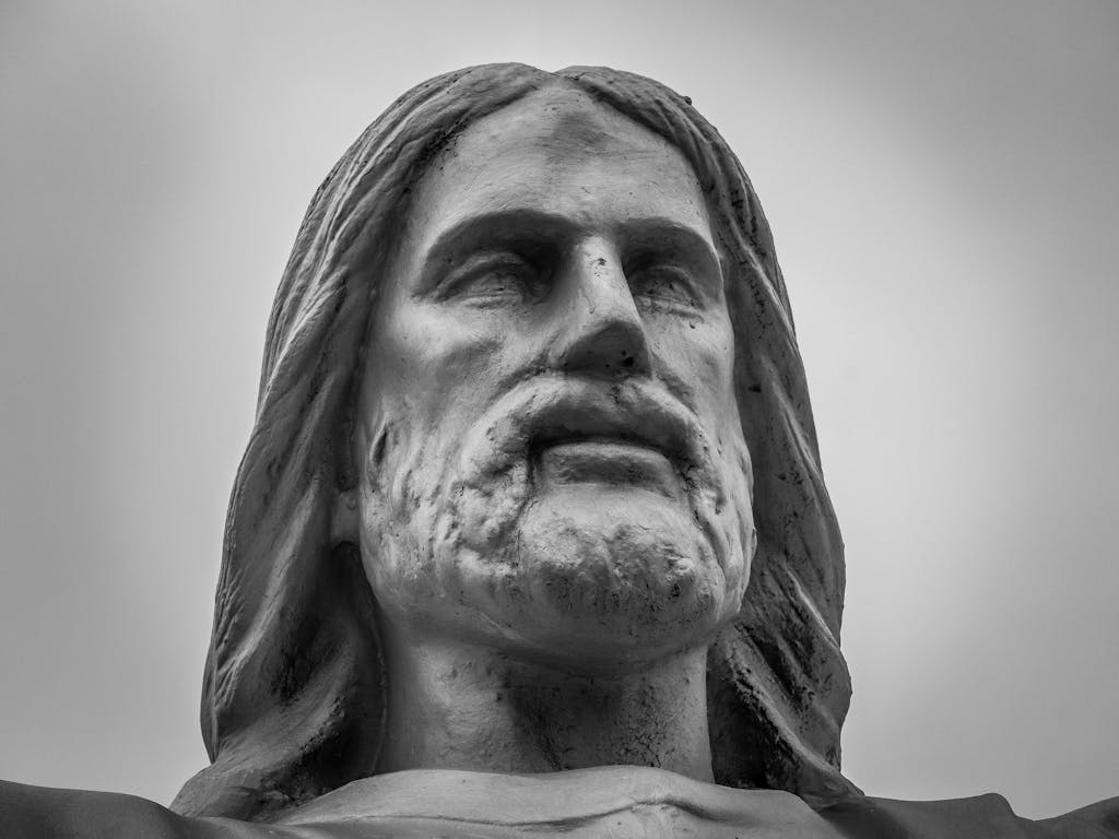 Shri Hanuman Dham: A striking black and white photo of a Jesus Christ statue's face, capturing solemnity.