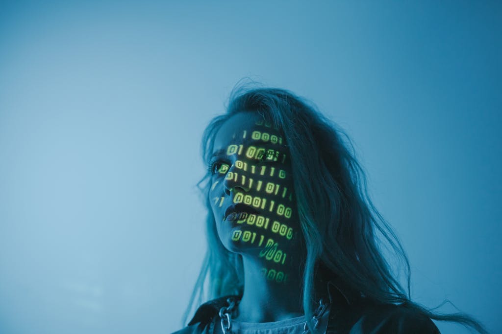 Angel Numbers A woman with binary code lights projected on her face, symbolizing technology.