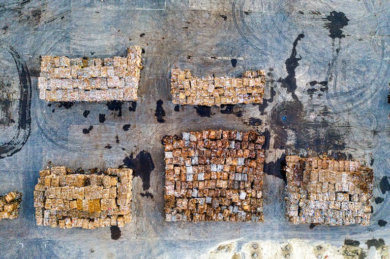 MataRecycler: Aerial shot of organized recyclable material stacks in Serang, Indonesia, highlighting waste management efforts.