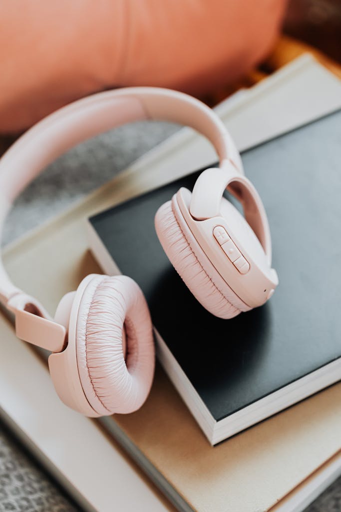 Close-up of stylish wireless headphones on a stack of books.