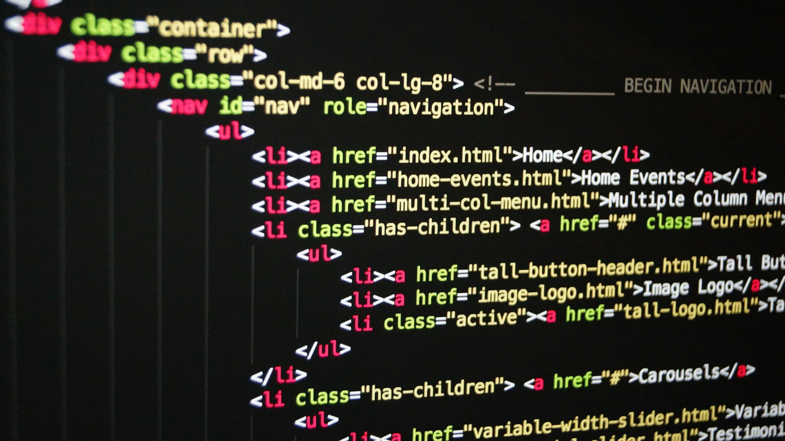 Pxless Design: Close-up of vibrant HTML code displayed on a computer screen, showcasing web development and programming.