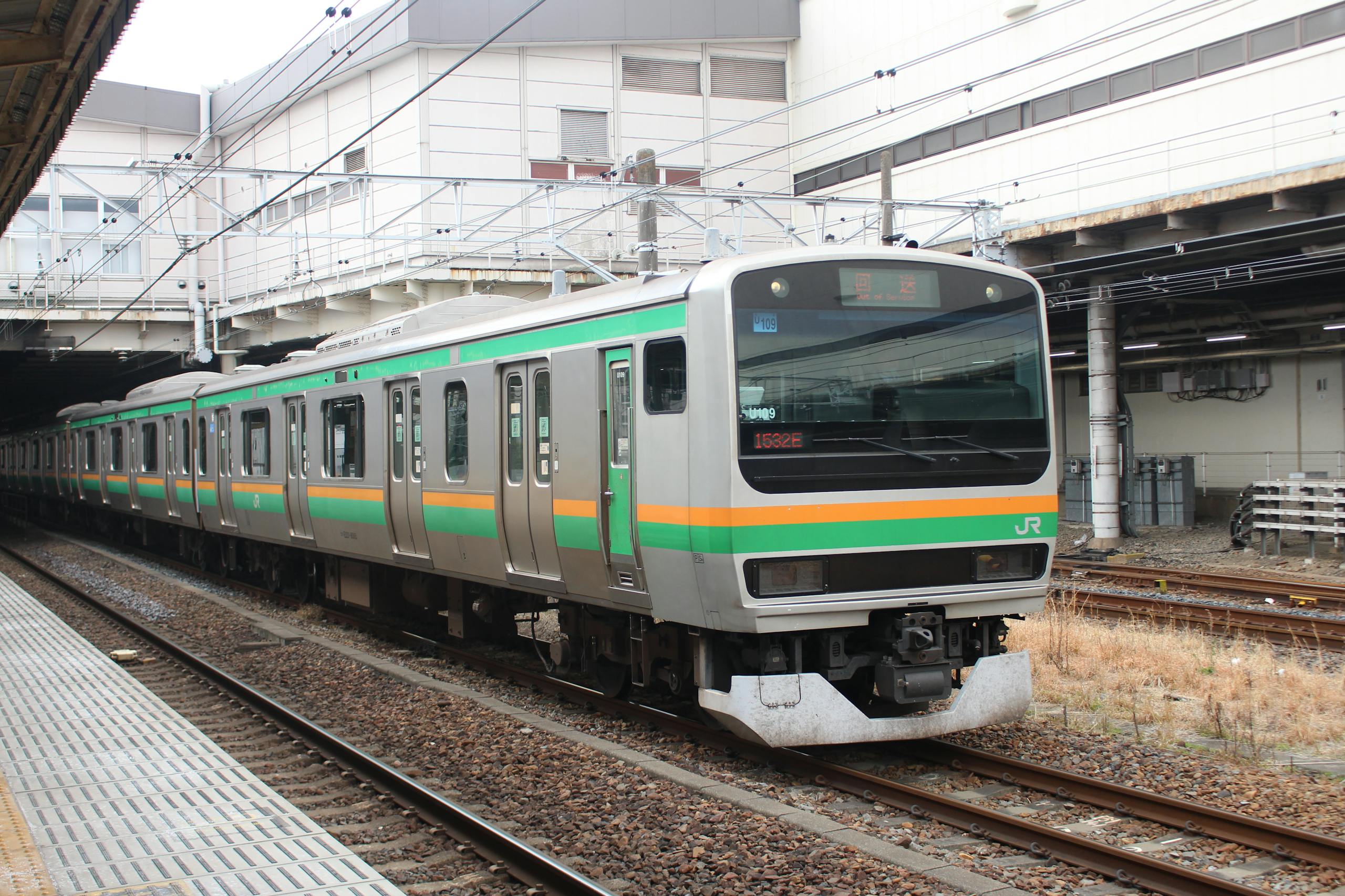 Claude Edward Elkins Jr Commuter train at Utsunomiya Station, highlighting Japan's efficient rail system.