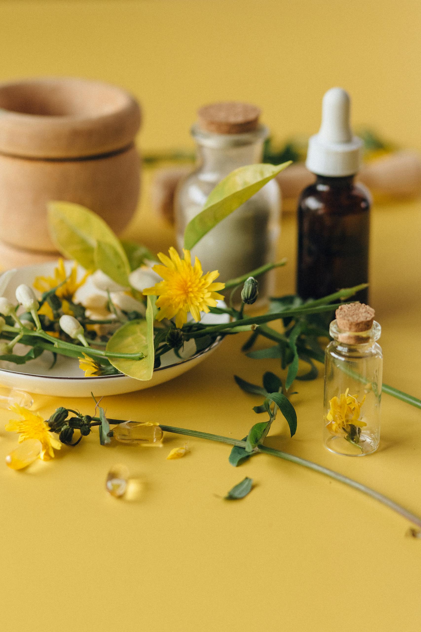Well health organic ayurveda Dried herbs and essential oils on a yellow background, perfect for natural health concepts.
