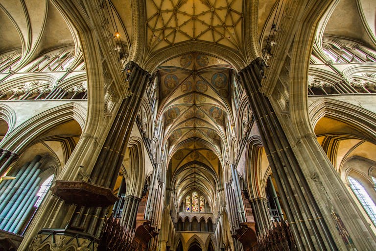 Hanuman Dham:Experience the intricate Gothic architecture of Salisbury Cathedral's interior with stunning vaulted ceilings.