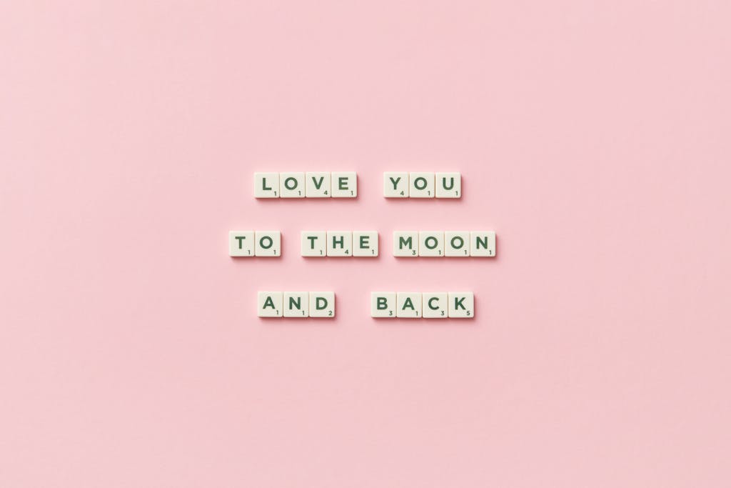 Laaster Letter tiles spelling 'Love You to the Moon and Back' on a pink background.