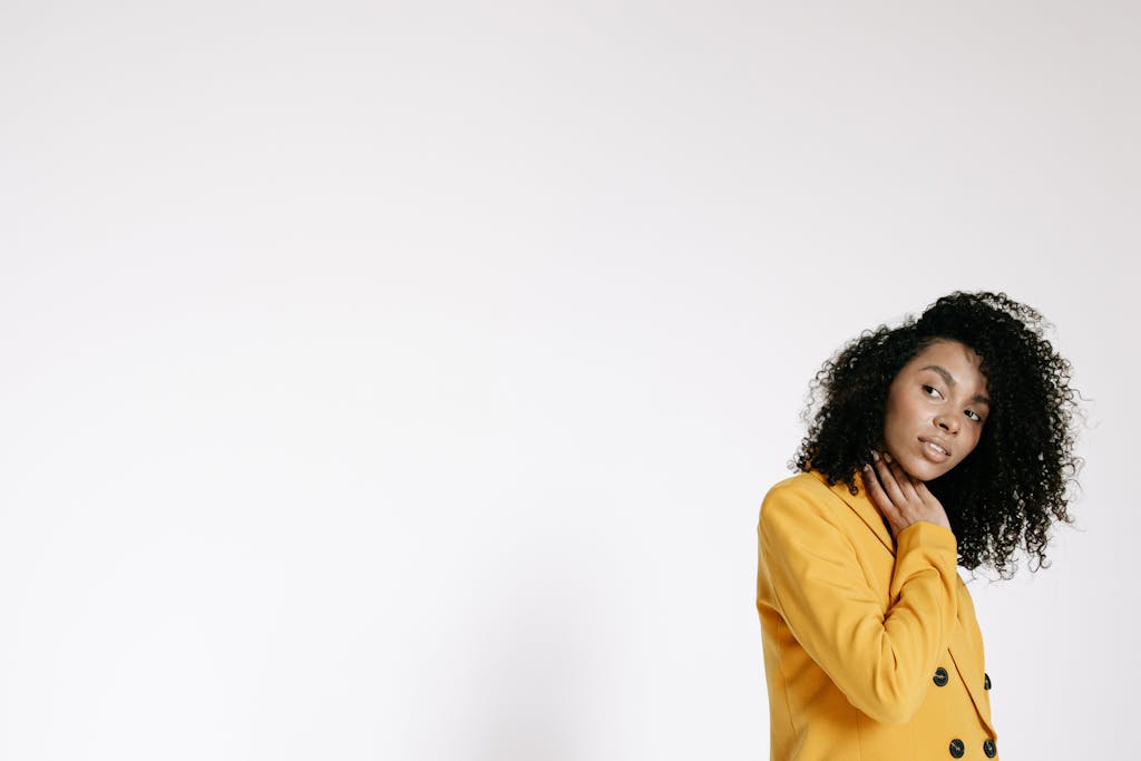 Laaster: Meaning, Uses, Trends, and Everything You Should Know  Stylish portrait of a woman in a yellow jacket with a white background, exuding confidence and elegance.