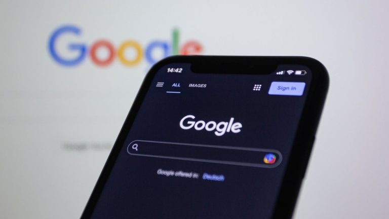 Best API Search Companies and Their HomepagesSmartphone screen showing Google search in dark mode with the Google logo in the background.