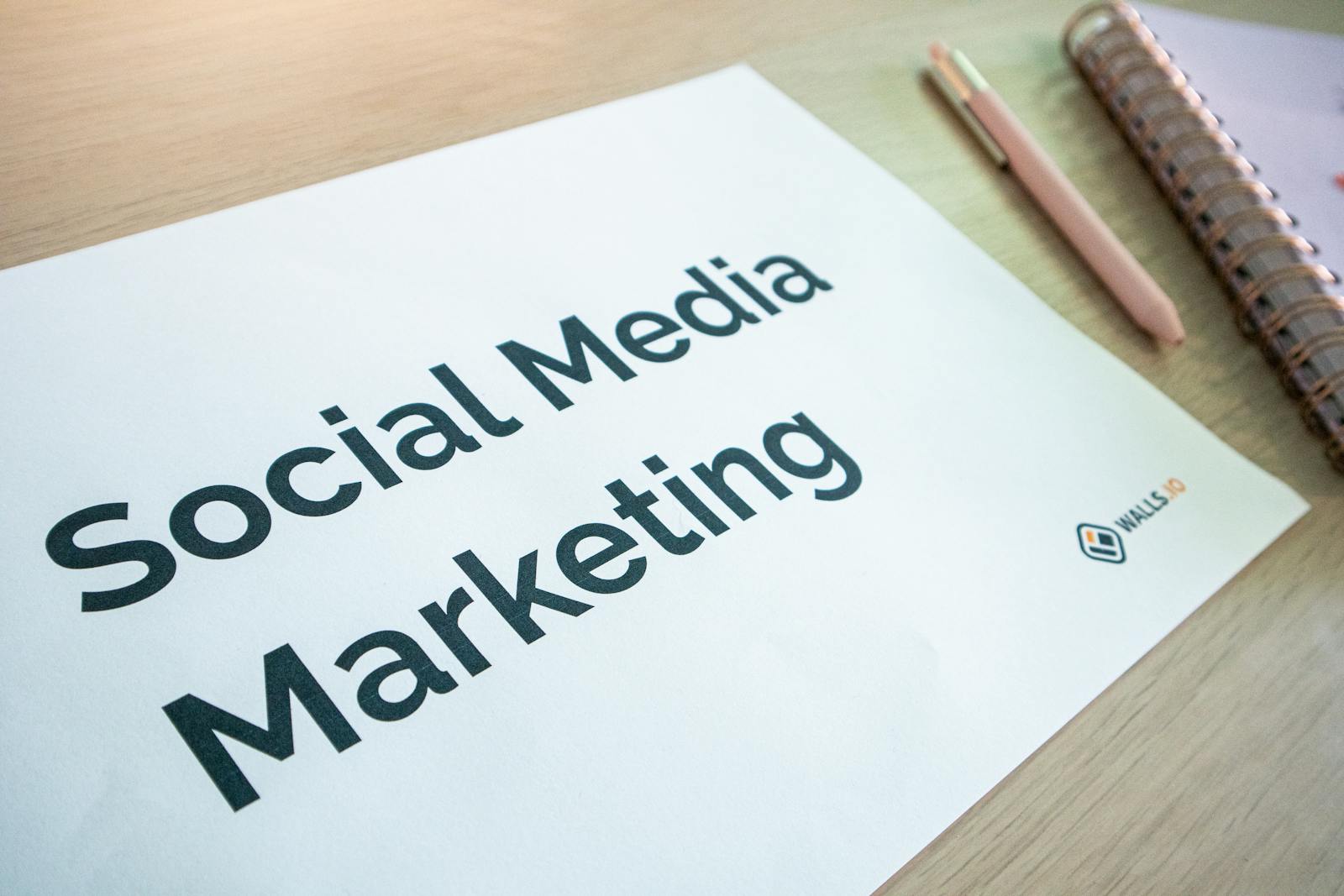 Ventsmagazine.cloud Close-up of a social media marketing document on a desk with a pen and notebook.
