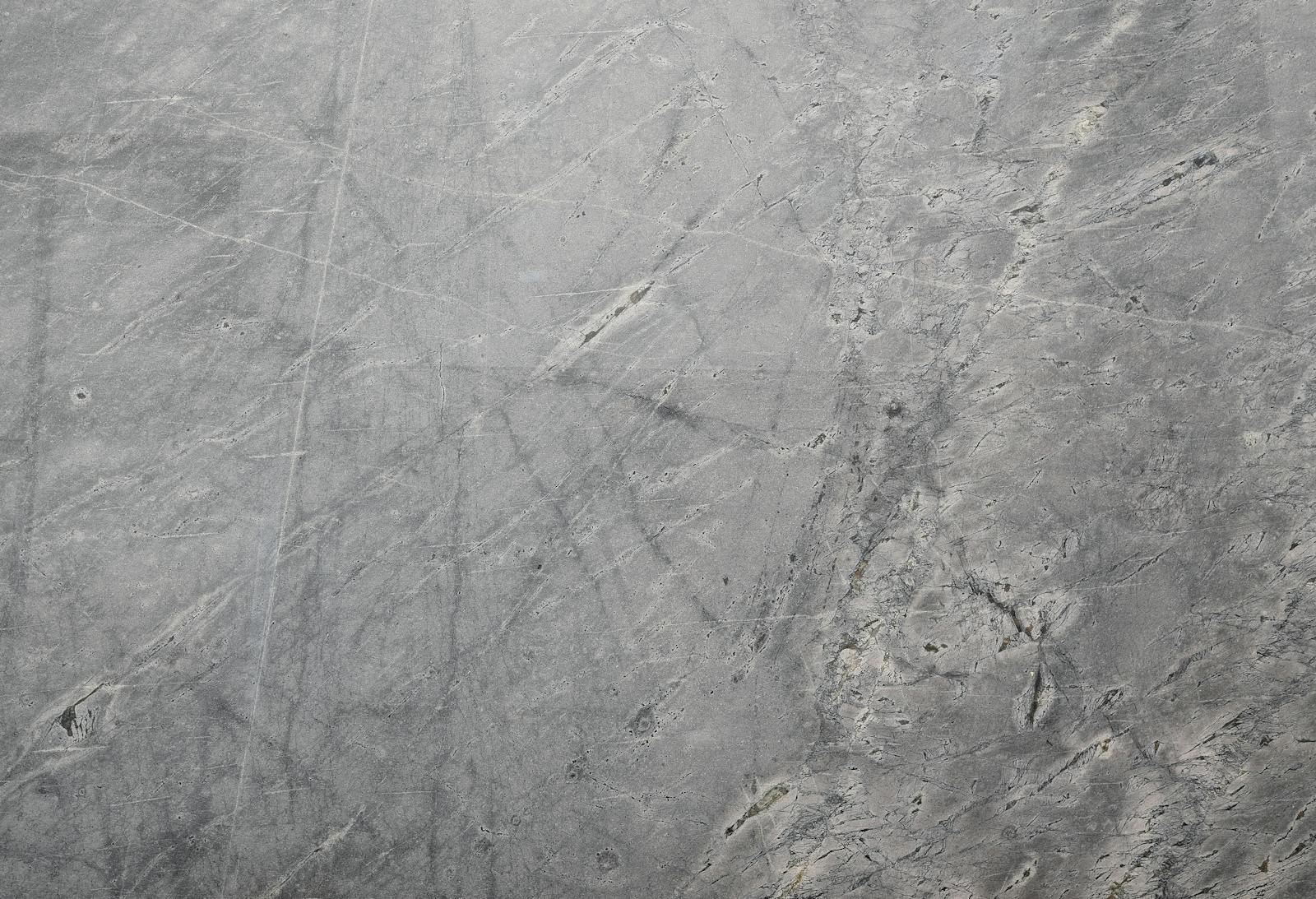 Newtopy Close-up of a textured grey stone surface suitable for backgrounds or wallpapers.