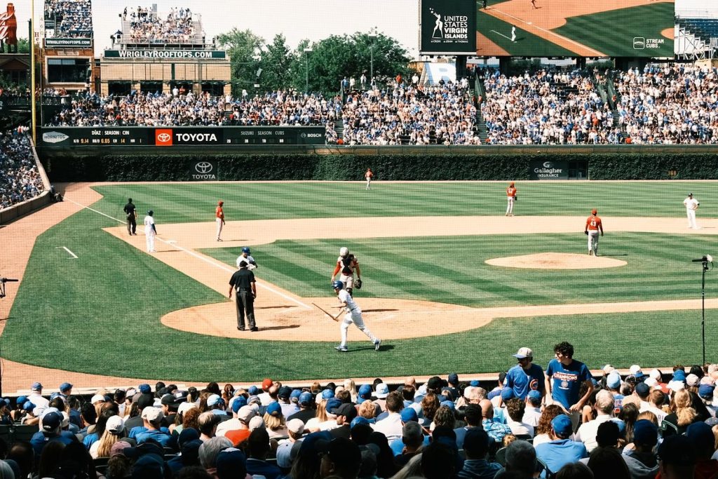 Chicago Cubs Vibrant scene of a baseball game at Wrigley Field with packed grandstands and players in action.