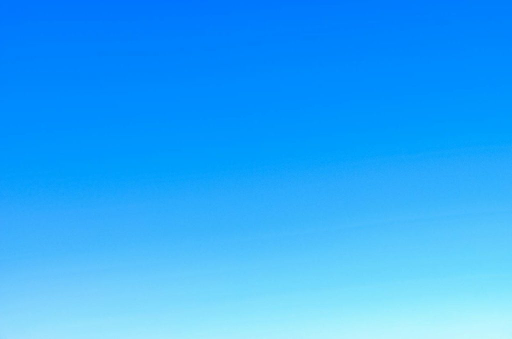 Newtopy A serene view of a vibrant clear blue sky with a subtle gradient, perfect for backgrounds.