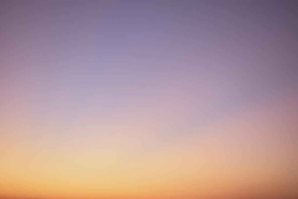 Newtopy A serene gradient sky with hues of blue, pink, and orange during twilight.
