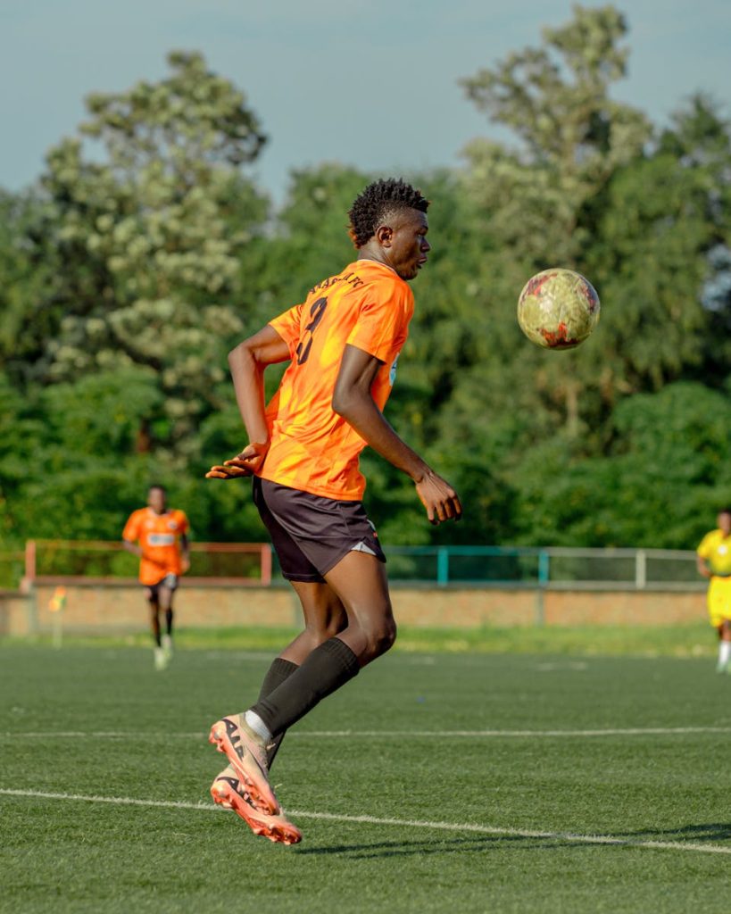 Bengals vs Cleveland Browns Match Player Stats A soccer player in orange kit skillfully controlling the ball on a sunny day.