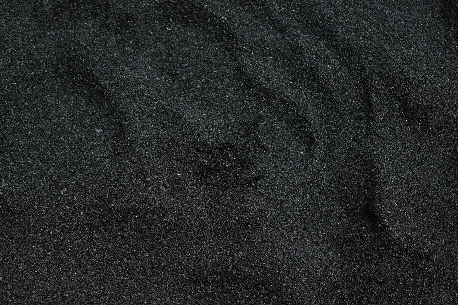 Emphyteymata Close-up of black sand texture from Waimea Beach in Hawaii. Ideal for backgrounds.