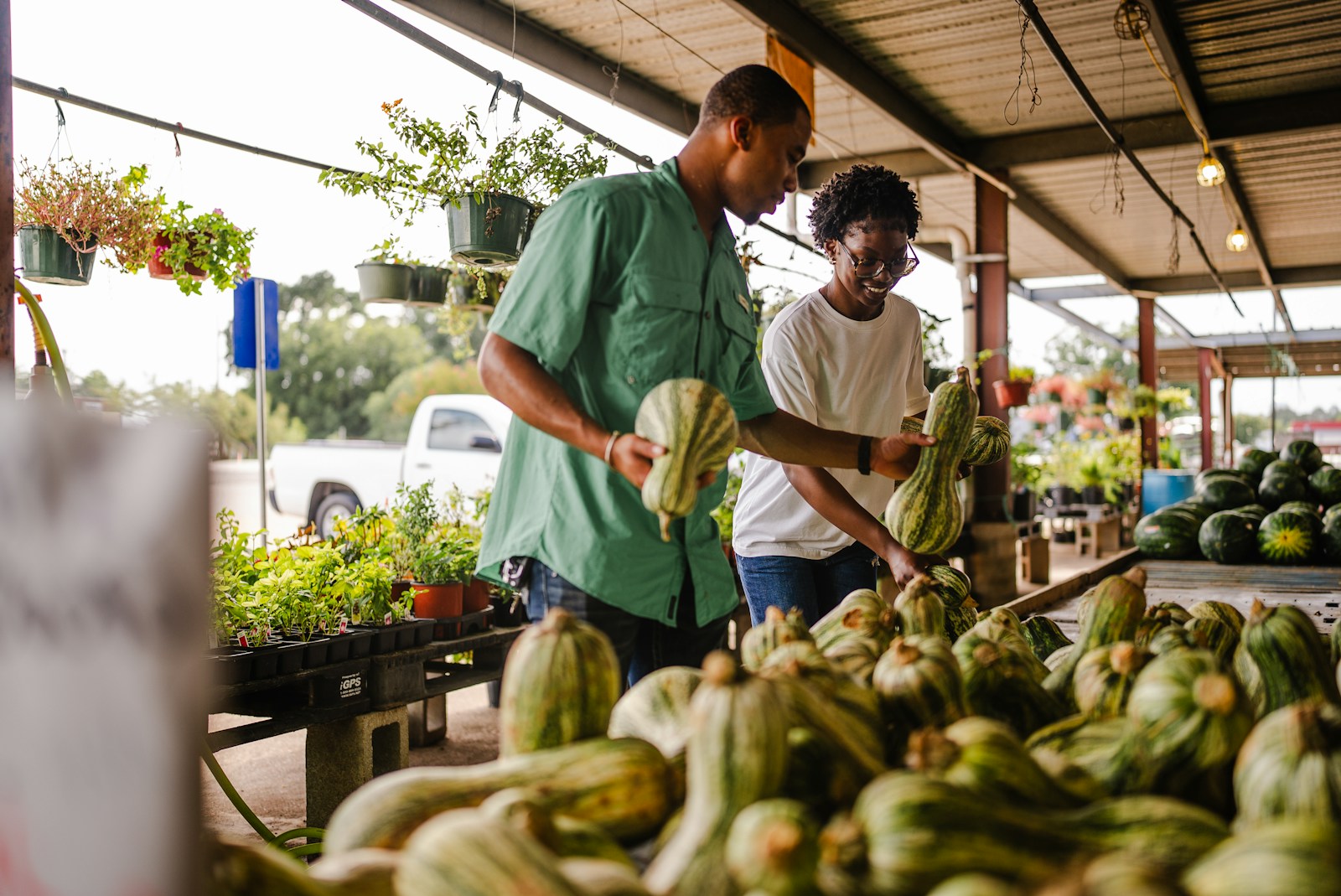 hj54kyf Couple shopping for gourds at an outdoor market.