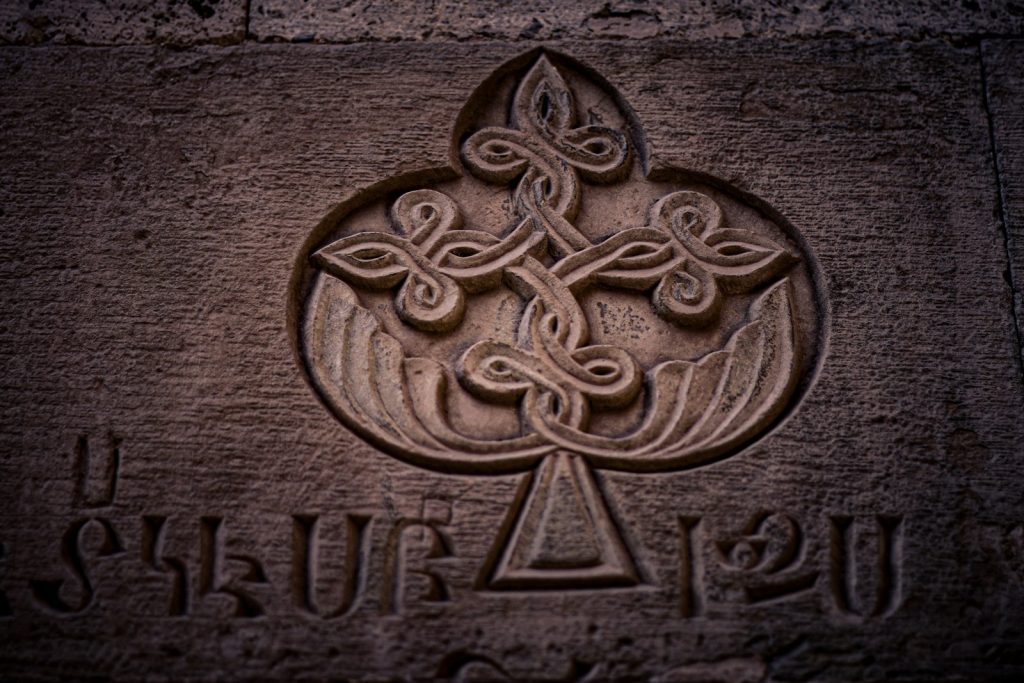 A close up of a stone with a cross on it