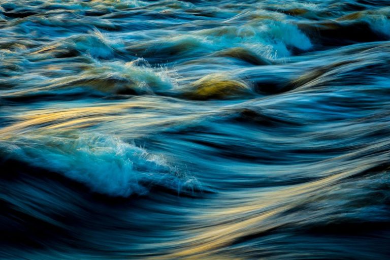 Trastel Capture of flowing ocean waves in motion, showcasing the vibrant colors and dynamic movement of water.
