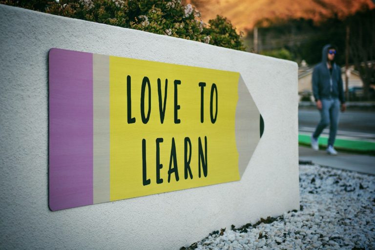 algebra.learning nexus.one love to learn pencil signage on wall near walking man